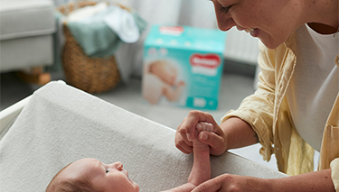 Mum changing bub with Huggies Nappy
