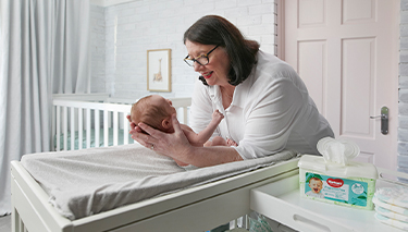 Midwife Cath holding bub